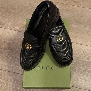 Gucci Black Leather Slip-Ons with Gold Emblem